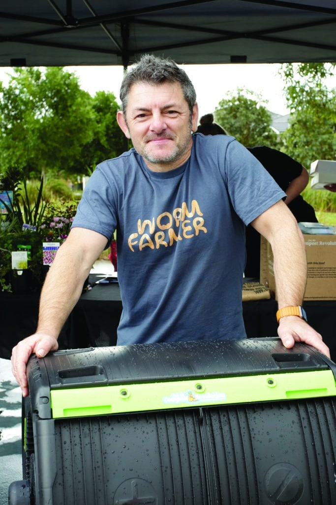 Photo of man holding a tumbler compost bin wearing a Worm Farmer tshirt